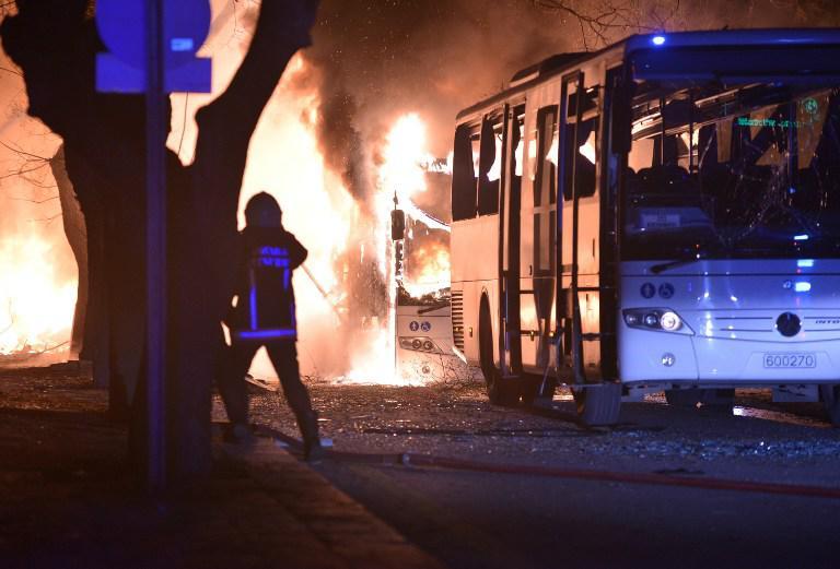 Firefighters try to extinguish flames following an explosion after an attack targeted a convoy of military service vehicles in Ankara on February 17, 2016. At least five people were killed and 10 people were wounded in a car bombing in the Turkish capital Ankara on February 17, the city's governor said. The attack targeted a convoy of military service vehicles, Ankara governor Mehmet Kiliclar said, quoted by the CNN-Turk and NTV channels. / AFP / STRINGER