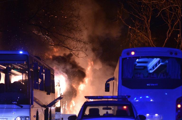 TURKEY OUT Firefighters try to extinguish flames following an explosion after an attack targeted a convoy of military service vehicles in Ankara on February 17, 2016. At least five people were killed and 10 people were wounded in a car bombing in the Turkish capital Ankara on February 17, the city's governor said. The attack targeted a convoy of military service vehicles, Ankara governor Mehmet Kiliclar said, quoted by the CNN-Turk and NTV channels. / AFP / IHLAS NEWS AGENCY / STRINGER / Turkey OUT