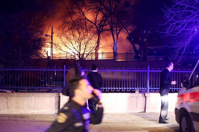 Firefighters try to extinguish flames following an explosion after an attack targeted a convoy of military service vehicles in Ankara on February 17, 2016. At least five people were killed and 10 people were wounded in a car bombing in the Turkish capital Ankara on February 17, the city's governor said. The attack targeted a convoy of military service vehicles, Ankara governor Mehmet Kiliclar said, quoted by the CNN-Turk and NTV channels. / AFP / EROL UCEM
