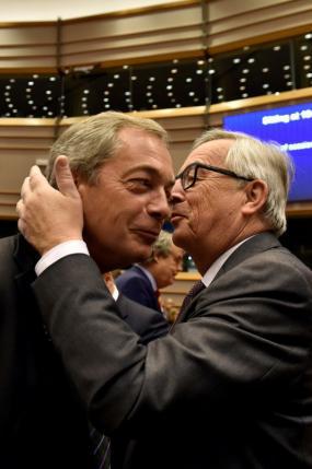 EC President Juncker kisses Farage, the leader of the UKIP, prior to a plenary session at the European Parliament on the outcome of the "Brexit" in Brussels