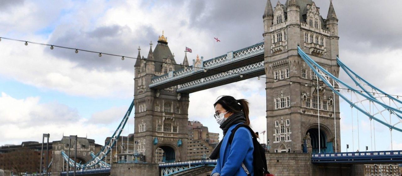 γυναίκα με μάσκα δίπλα από τη London Bridge στο Λονδίνο στη Βρετανία