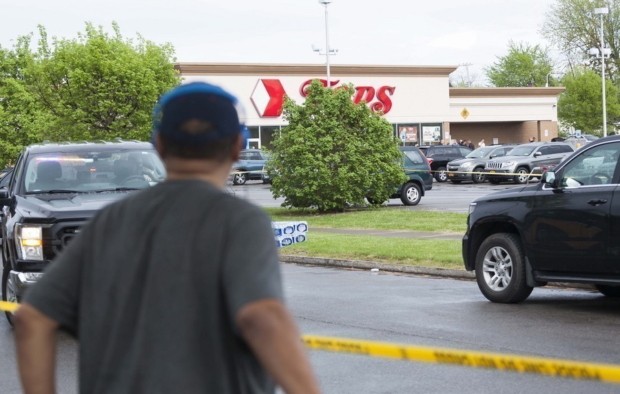 A man standing in front of police tape looks at the scene of a mass shooting at the Tops Friendly Market grocery store in Buffalo, New York, USA, 14 May 2022. A gunman, who has been taken into custody by police, reportedly opened fire at the market killing as many as 10 people. EPA/BRANDON WATSON