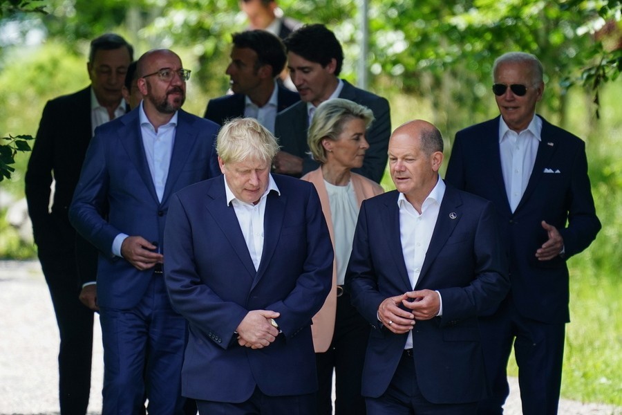 Britain's Prime Minster Boris Johnson (L) talks to German Chancellor Olaf Scholz (R), as they walk during G7 summit at Elmau Castle in Kruen, Germany, 26 June 2022. Germany is hosting the G7 summit at Elmau Castle near Garmisch-Partenkirchen from 26 to 28 June 2022.