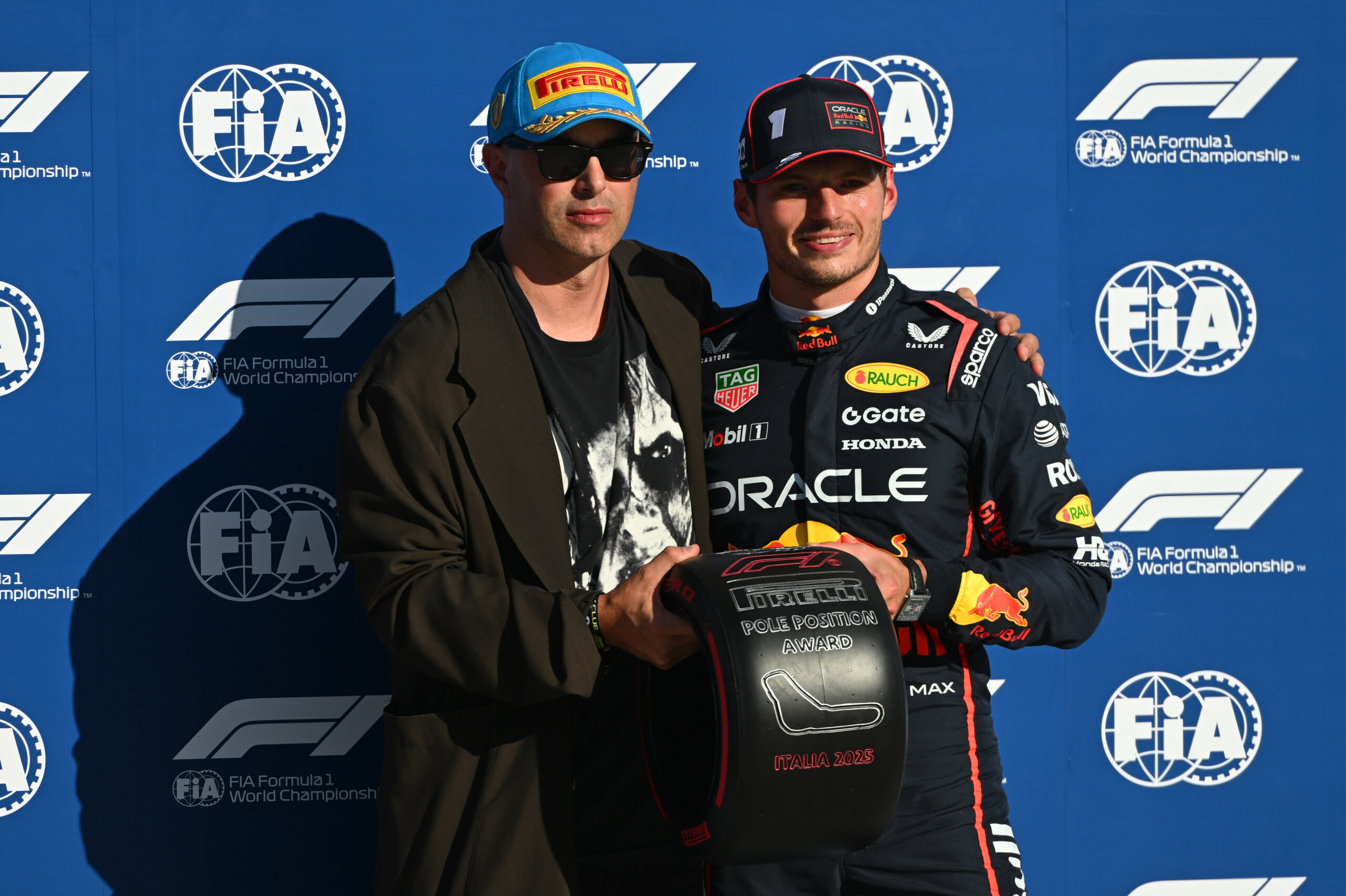 MONZA, ITALY - SEPTEMBER 06: Pole position qualifier Max Verstappen of the Netherlands and Oracle Red Bull Racing receives his Pirelli Pole Position Award from Nico Vascellari during qualifying ahead of the F1 Grand Prix of Italy at Autodromo Nazionale Monza on September 06, 2025 in Monza, Italy. (Photo by Rudy Carezzevoli/Getty Images) // Getty Images / Red Bull Content Pool // SI202509060498 // Usage for editorial use only //