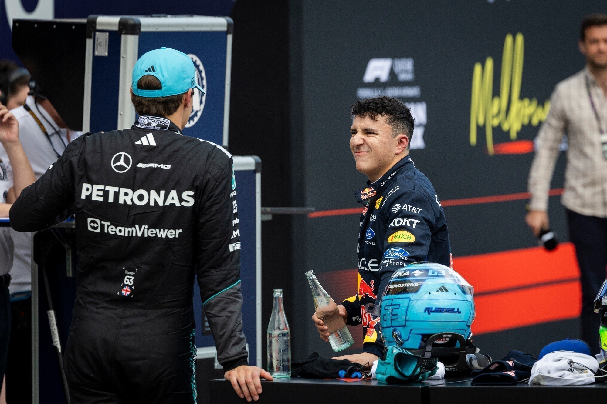 MELBOURNE, AUSTRALIA - MARCH 07: Pole position qualifier George Russell of Great Britain and Mercedes AMG Petronas F1 Team and Third placed qualifier Isack Hadjar of France and Oracle Red Bull Racing talk in parc ferme during qualifying ahead of the F1 Grand Prix of Australia at Albert Park Grand Prix Circuit on March 07, 2026 in Melbourne, Australia. (Photo by Sam Bloxham/LAT Images) // Getty Images / Red Bull Content Pool // SI202603070337 // Usage for editorial use only //