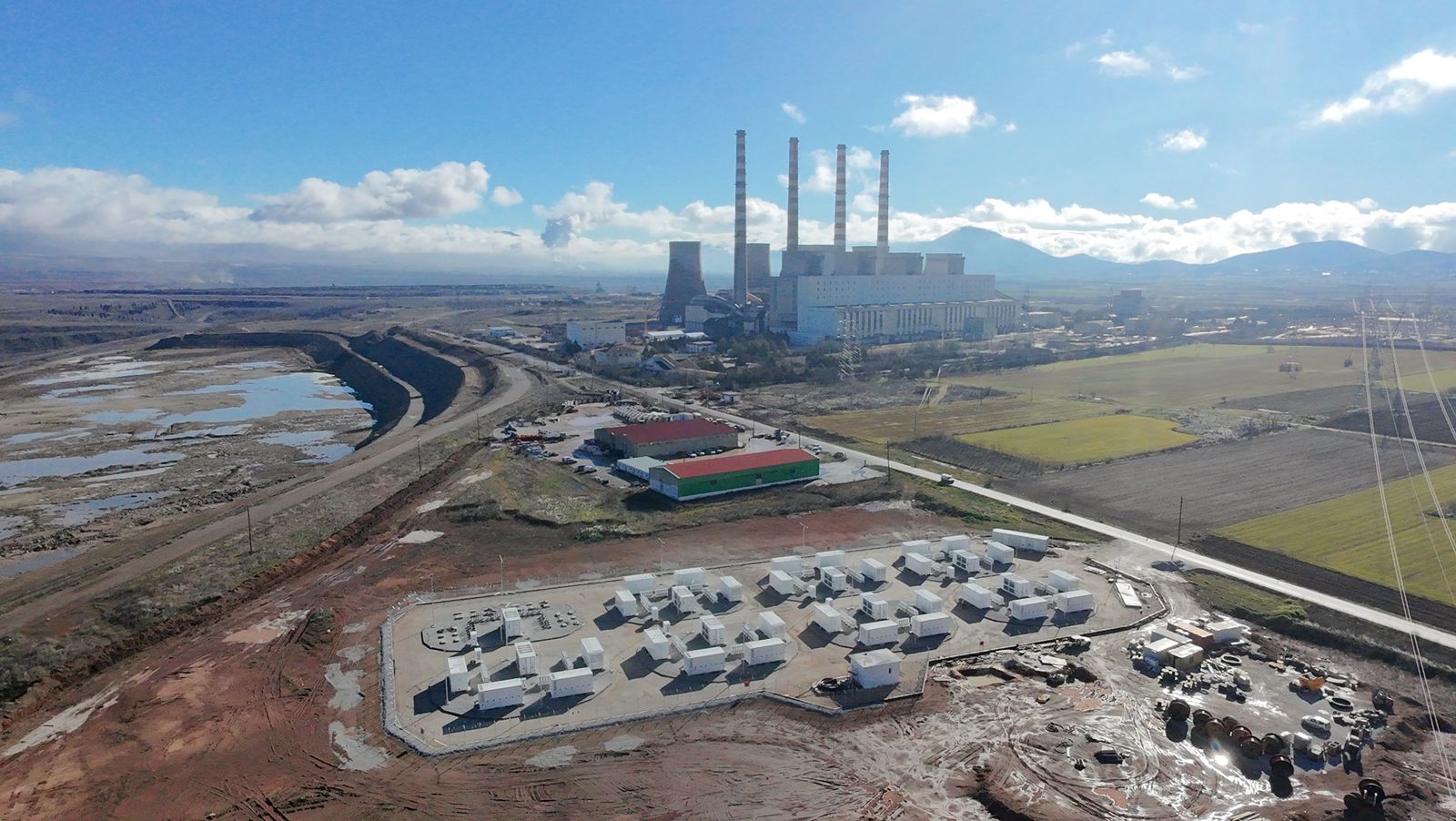 Συστοιχία συσσωρευτών του Σταθμού Ηλεκτροχημικής Αποθήκευσης Πτολεμαΐδας IV. Διακρίνεται ο ΑΗΣ Καρδιάς, αλλά και η θέση του κάτω ταμιευτήρα του μελλοντικού σταθμού αντλησιοταμίευσης